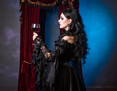 Gothic Vampire Woman Holding A Glass Of Red Wine