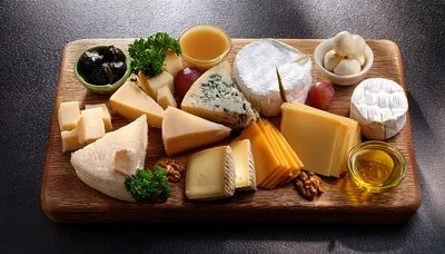 Gourmet Cheese Board With Assorted Cheeses And Accompaniments