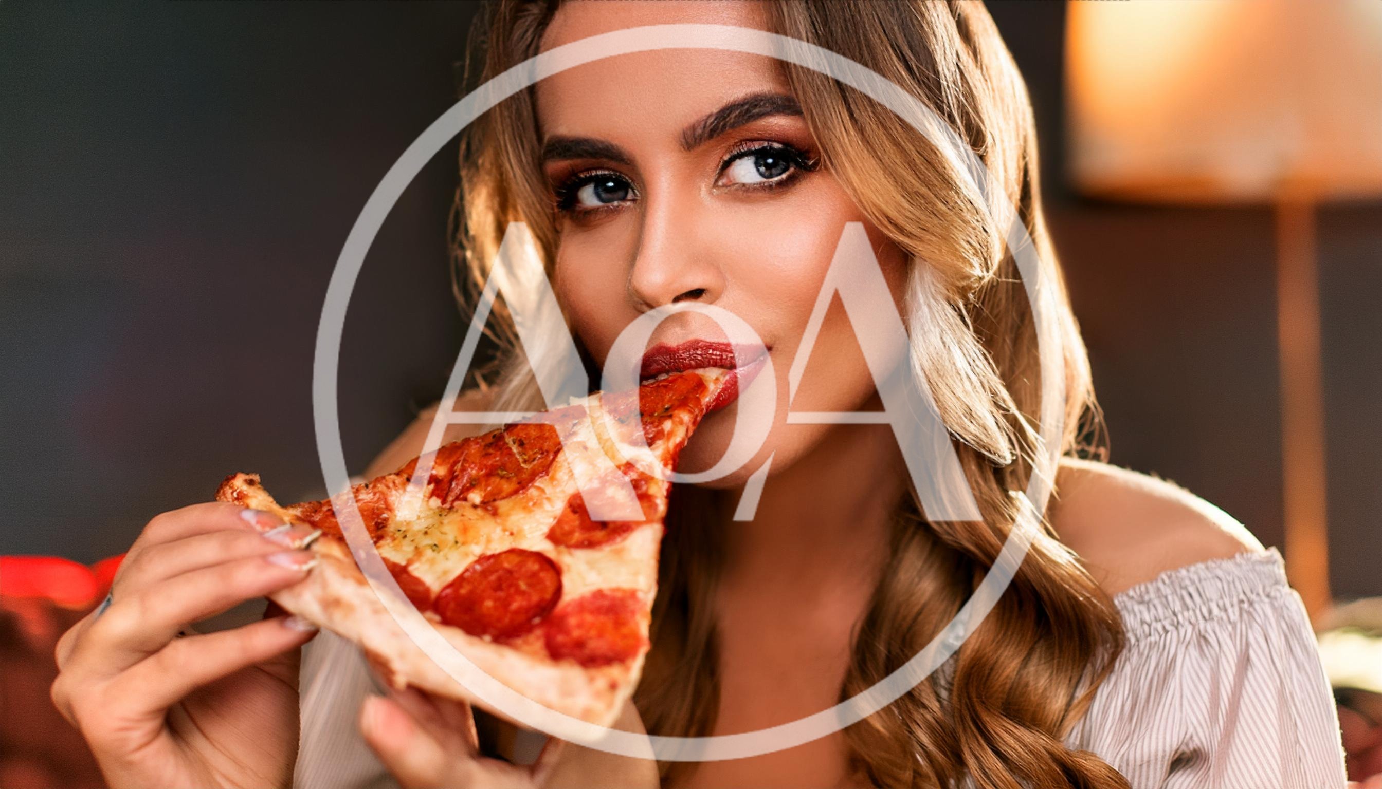 Beautiful Woman Eating A Slice Of Pepperoni Pizza