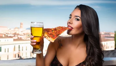 Beautiful Woman Eating Pizza And Drinking Beer Outdoors