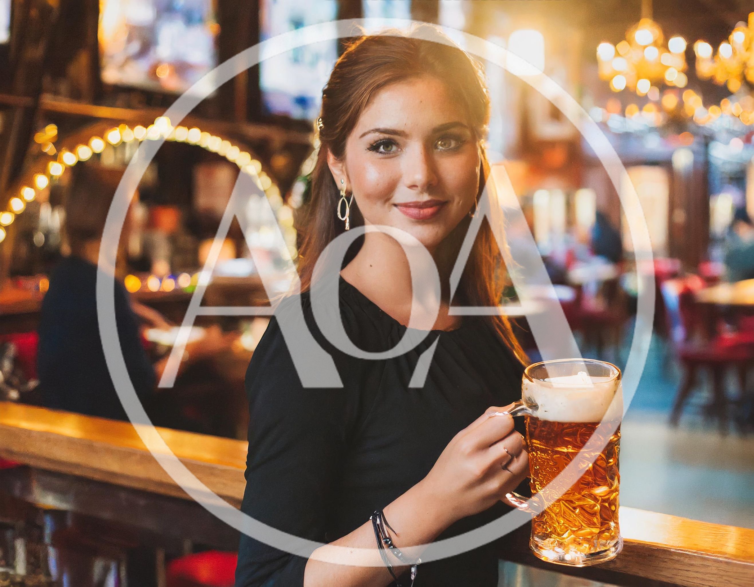 Young Woman Holding A Beer Mug In A Pub