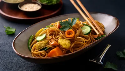 Stir Fried Noodles With Vegetables In A Ceramic Bowl