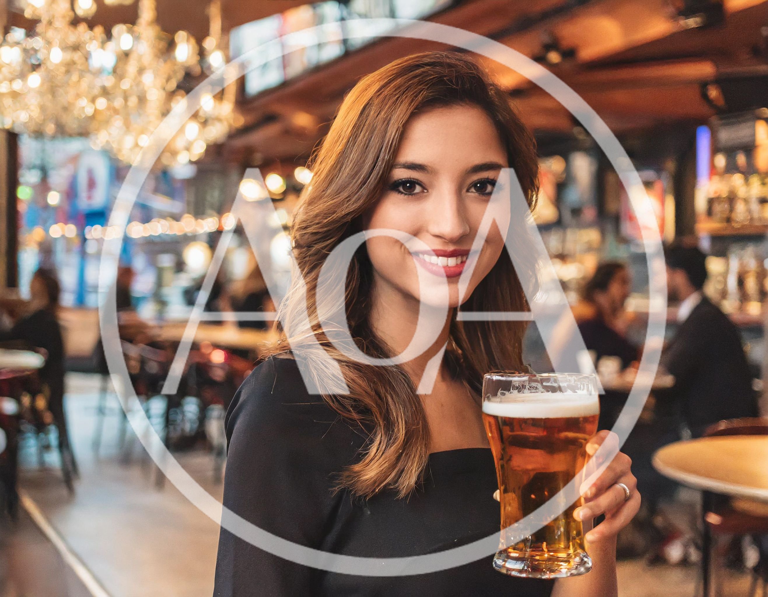 Young Woman Holding A Glass Of Beer In A Bar