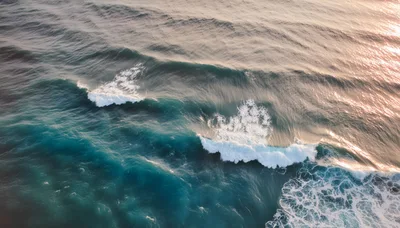 Aerial View Of Crashing Ocean Waves At Sunset