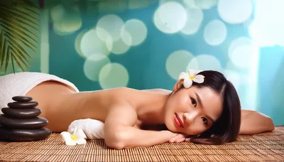 Young Asian Woman Relaxing During Spa Massage Treatment