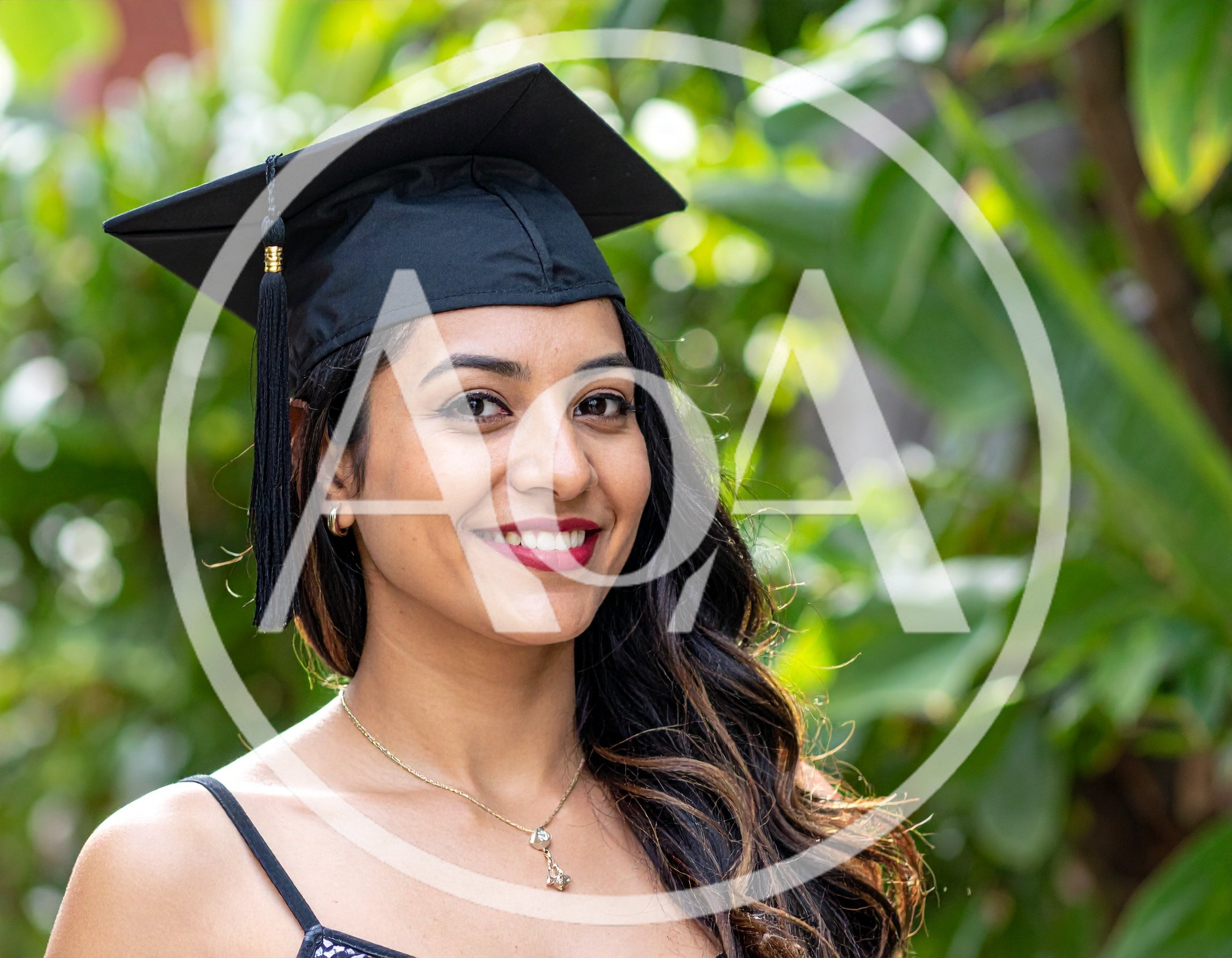 Smiling Young Woman Wearing Graduation Cap Outdoors