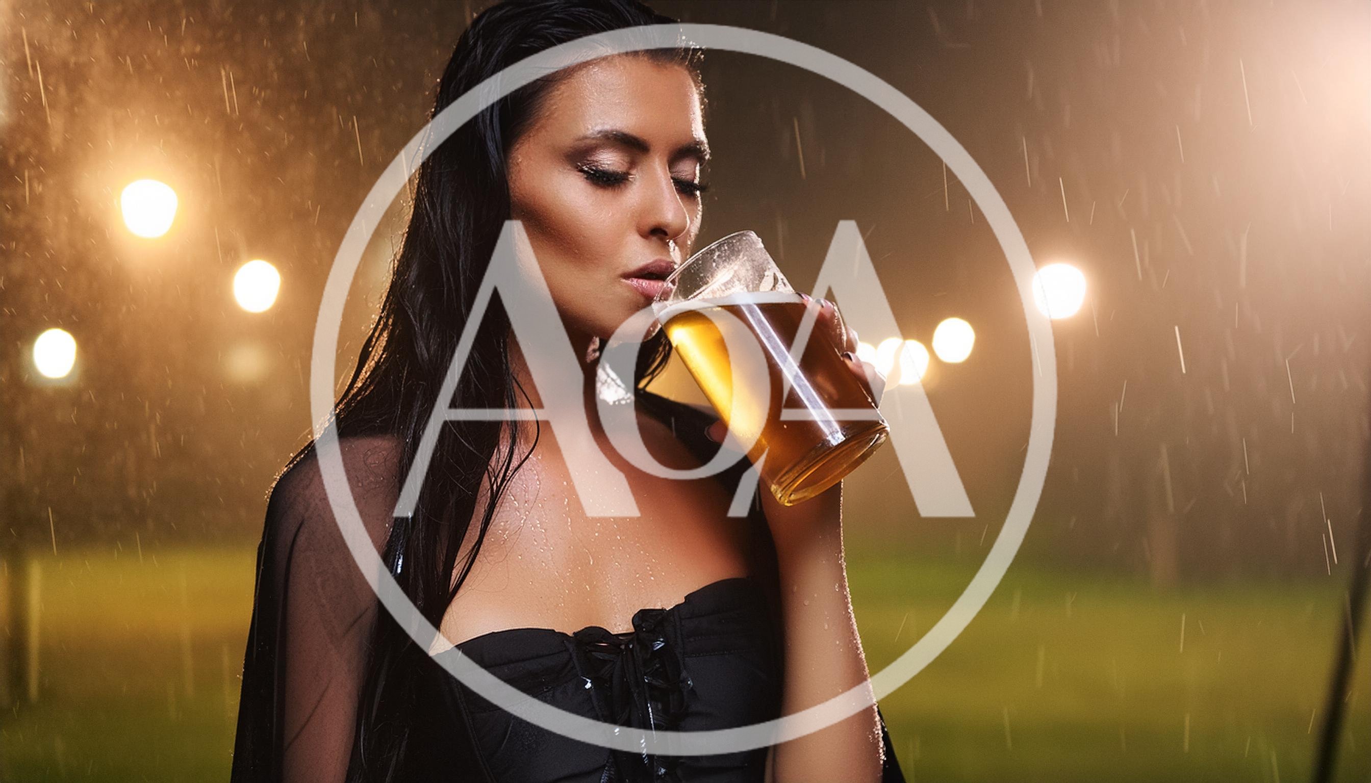 Woman Drinking Beer Outdoors During Night Rain