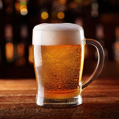 Cold Glass Mug Of Golden Beer On Wooden Table