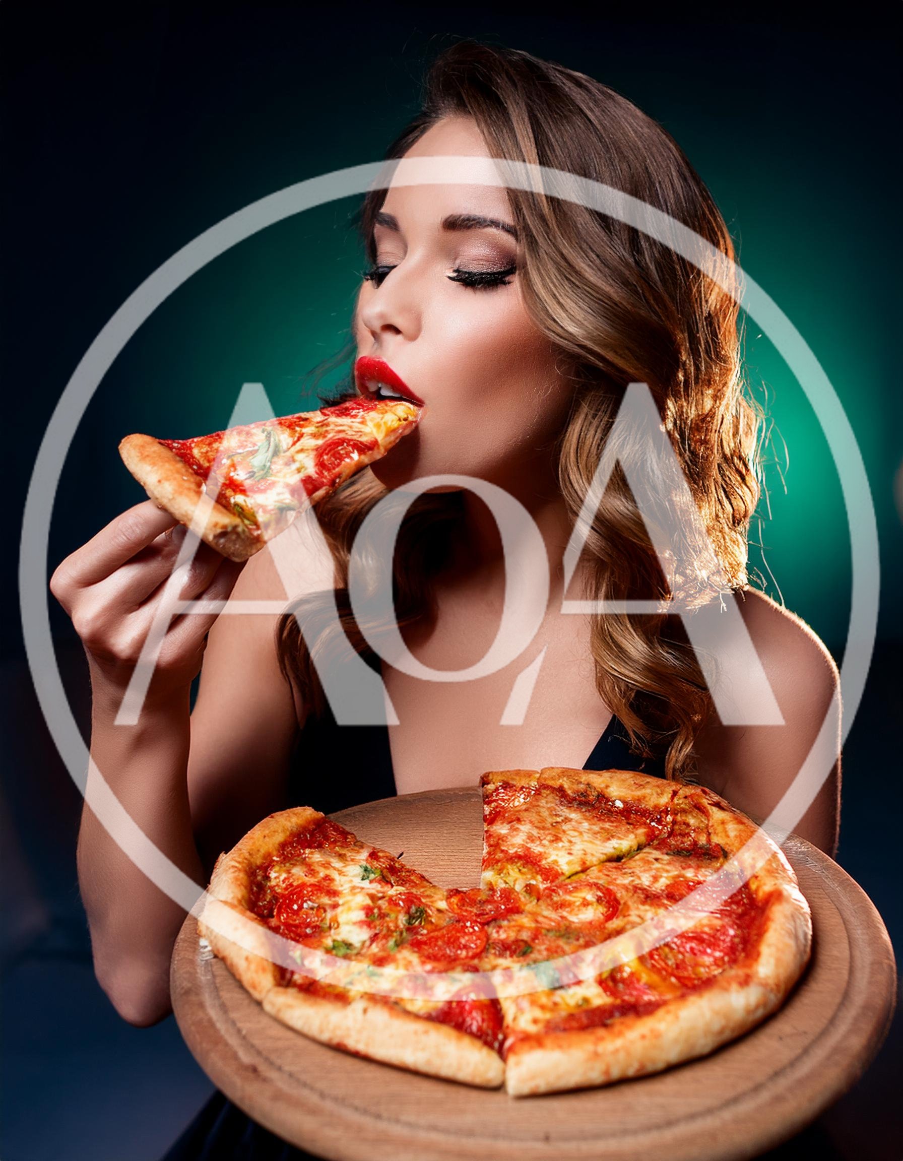 Beautiful Woman Eating A Slice Of Fresh Pizza