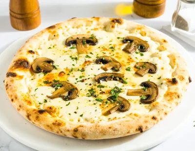 Freshly Baked Mushroom Pizza On A White Plate