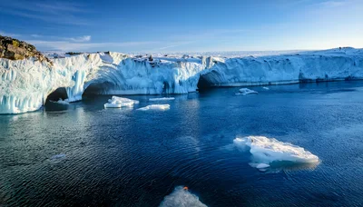 Glacier Ice Shelf With Floating Icebergs In Arctic Ocean