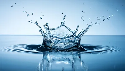 Water Crown Splash With Droplets On Blue Background