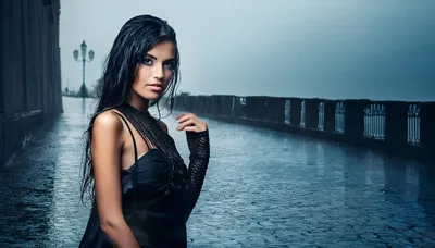 Elegant Woman Standing In The Rain On A Bridge