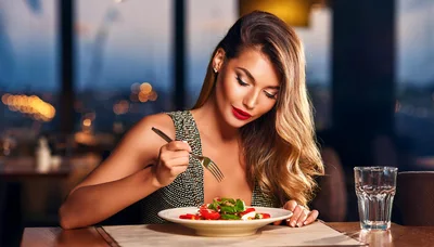 Elegant Woman Eating Fresh Salad In Upscale Restaurant