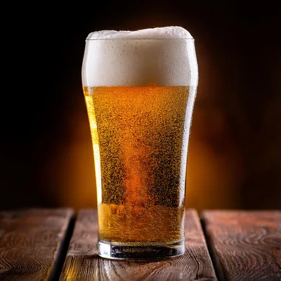 Cold Glass Of Golden Beer On Wooden Table