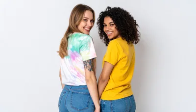 Two Diverse Young Women Smiling Back at Camera
