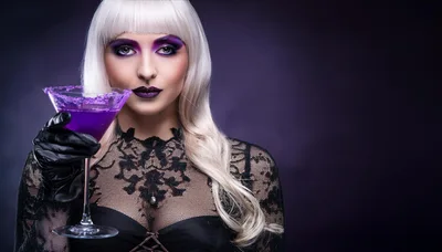 Woman With Platinum Hair Holding A Purple Cocktail