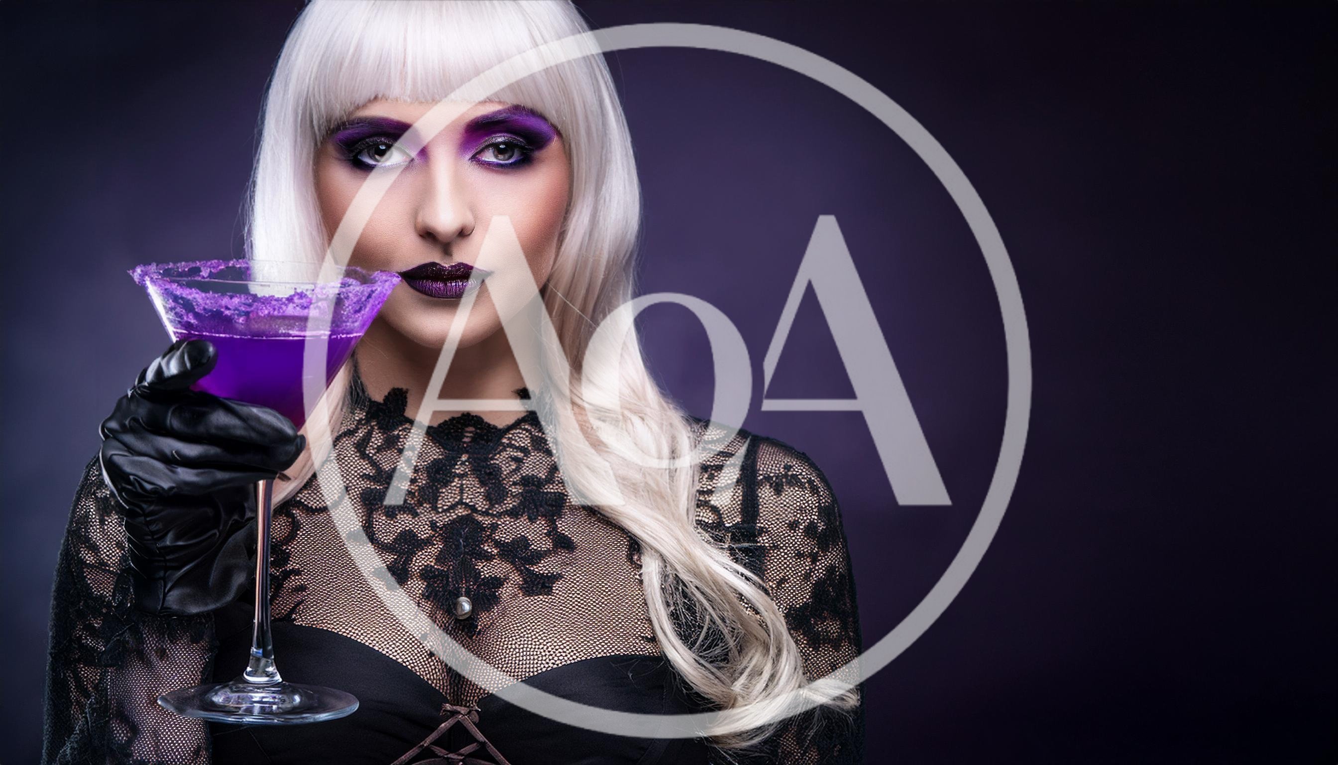 Woman With Platinum Hair Holding A Purple Cocktail