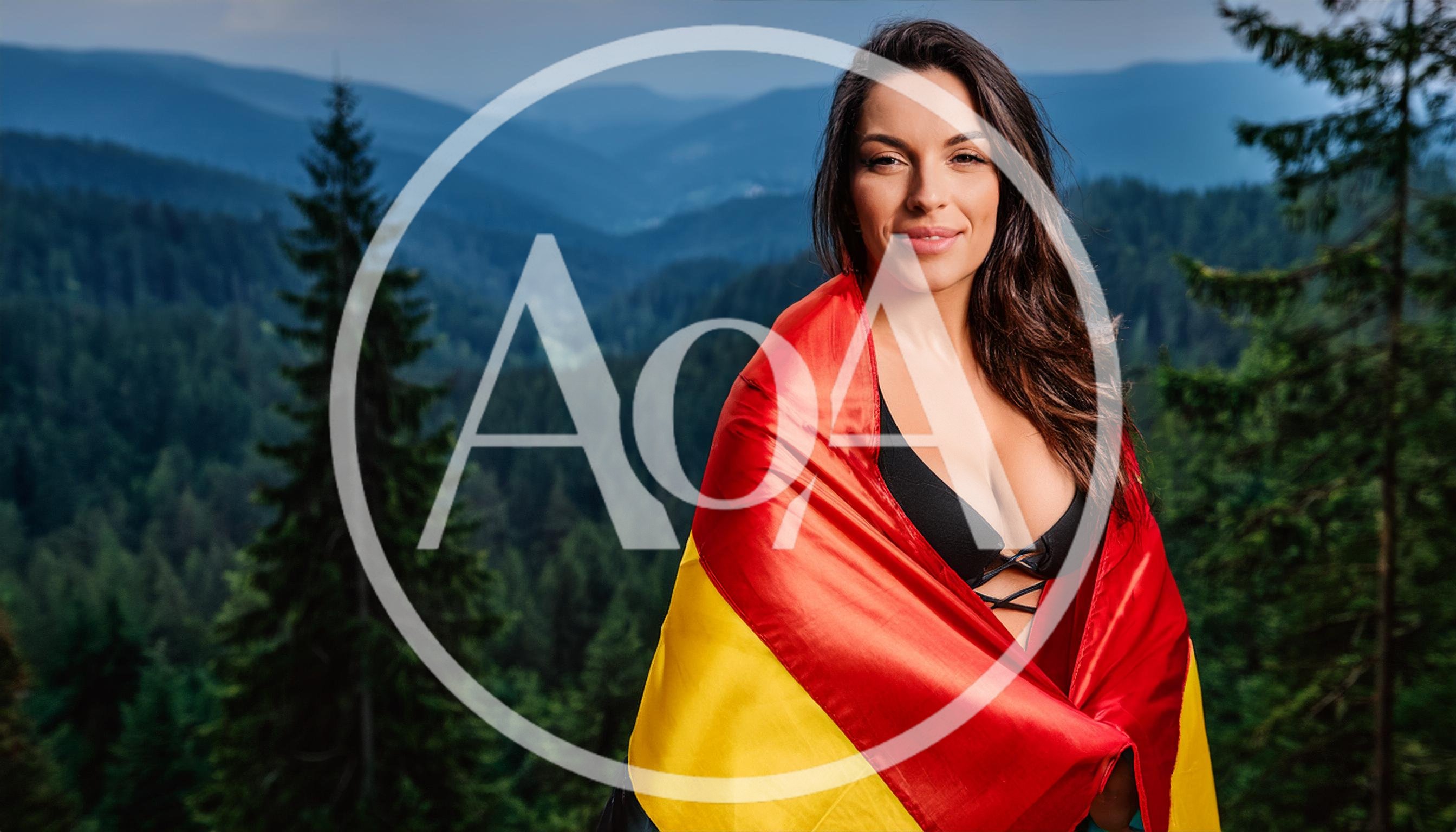 Woman Wrapped In German Flag Overlooking Mountain Forest