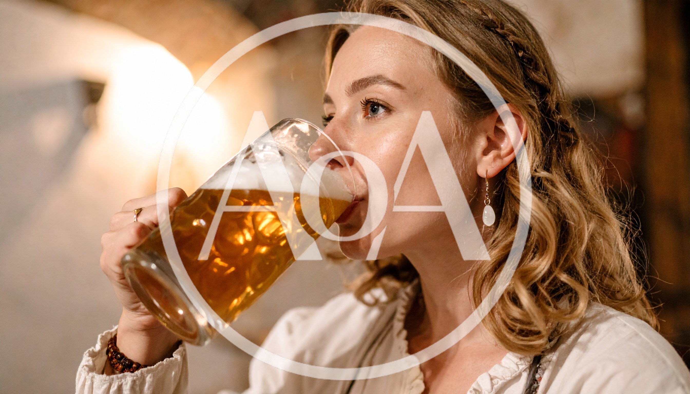 Young Woman Drinking Beer From A Large Glass Mug