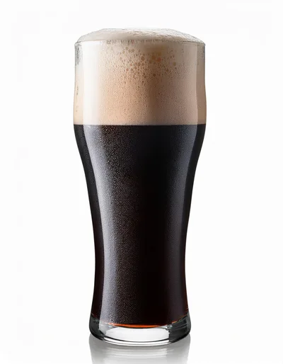 Glass Of Dark Stout Beer With Thick Foam