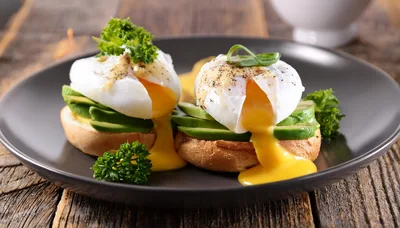 Two Poached Eggs On Avocado Toast With Hollandaise Sauce