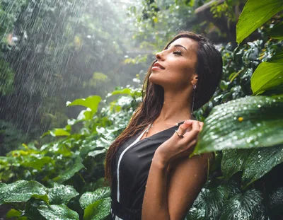 Woman Enjoying Tropical Rain In Lush Green Jungle