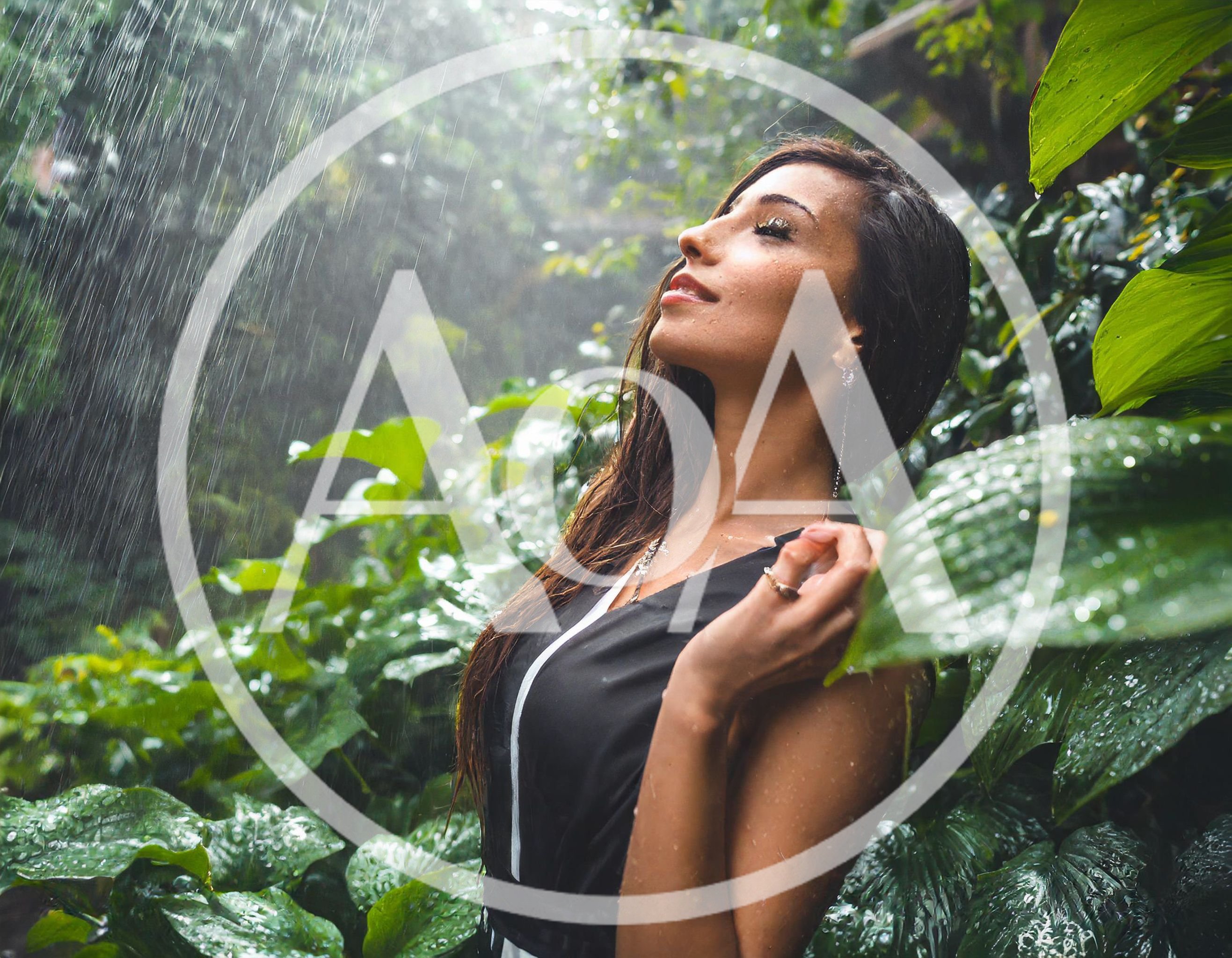 Woman Enjoying Tropical Rain In Lush Green Jungle