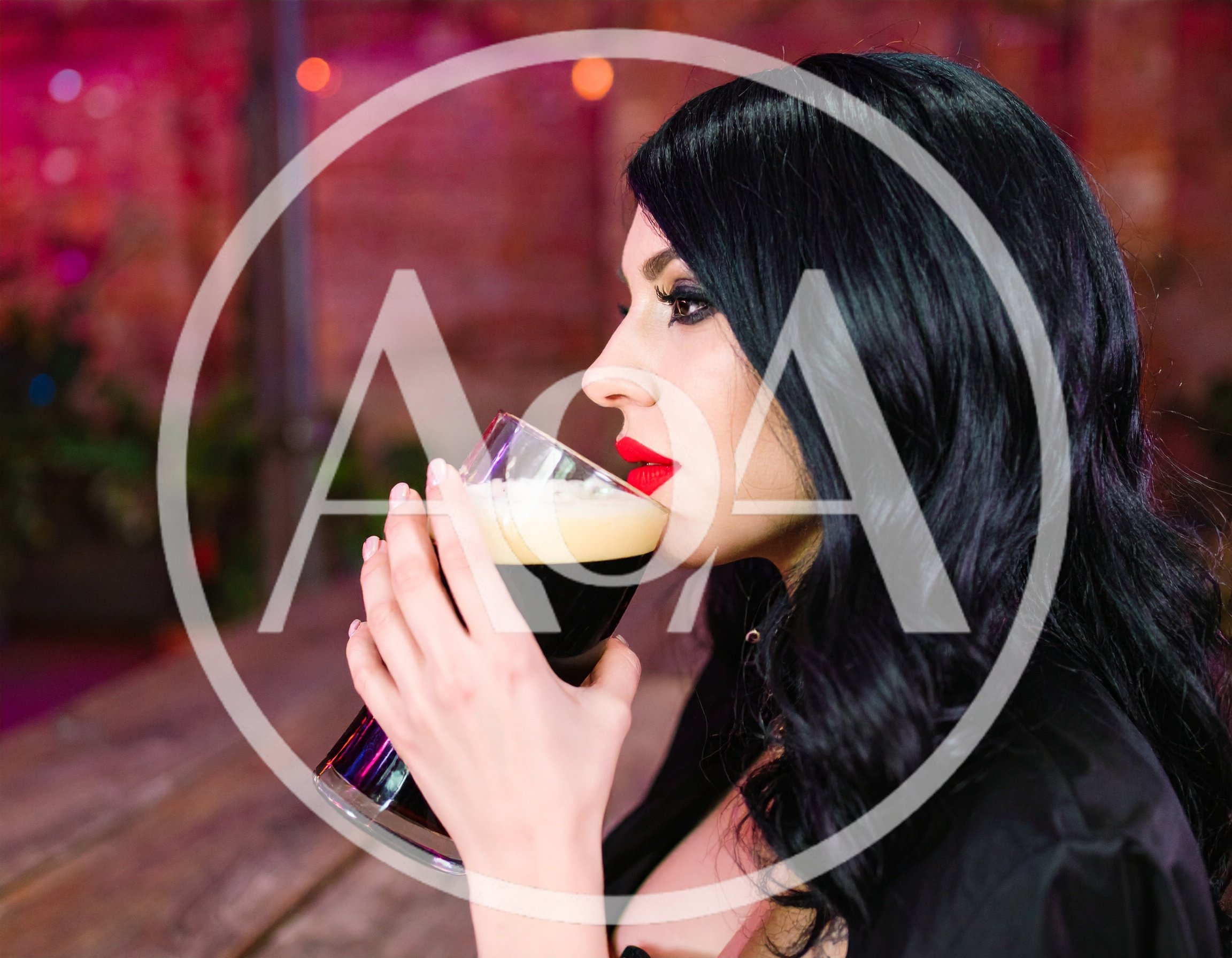 Woman Drinking Dark Beer In A Bar