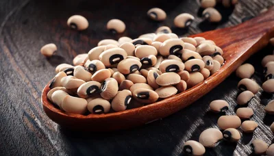 Wooden Spoon Filled With Raw Black Eyed Peas
