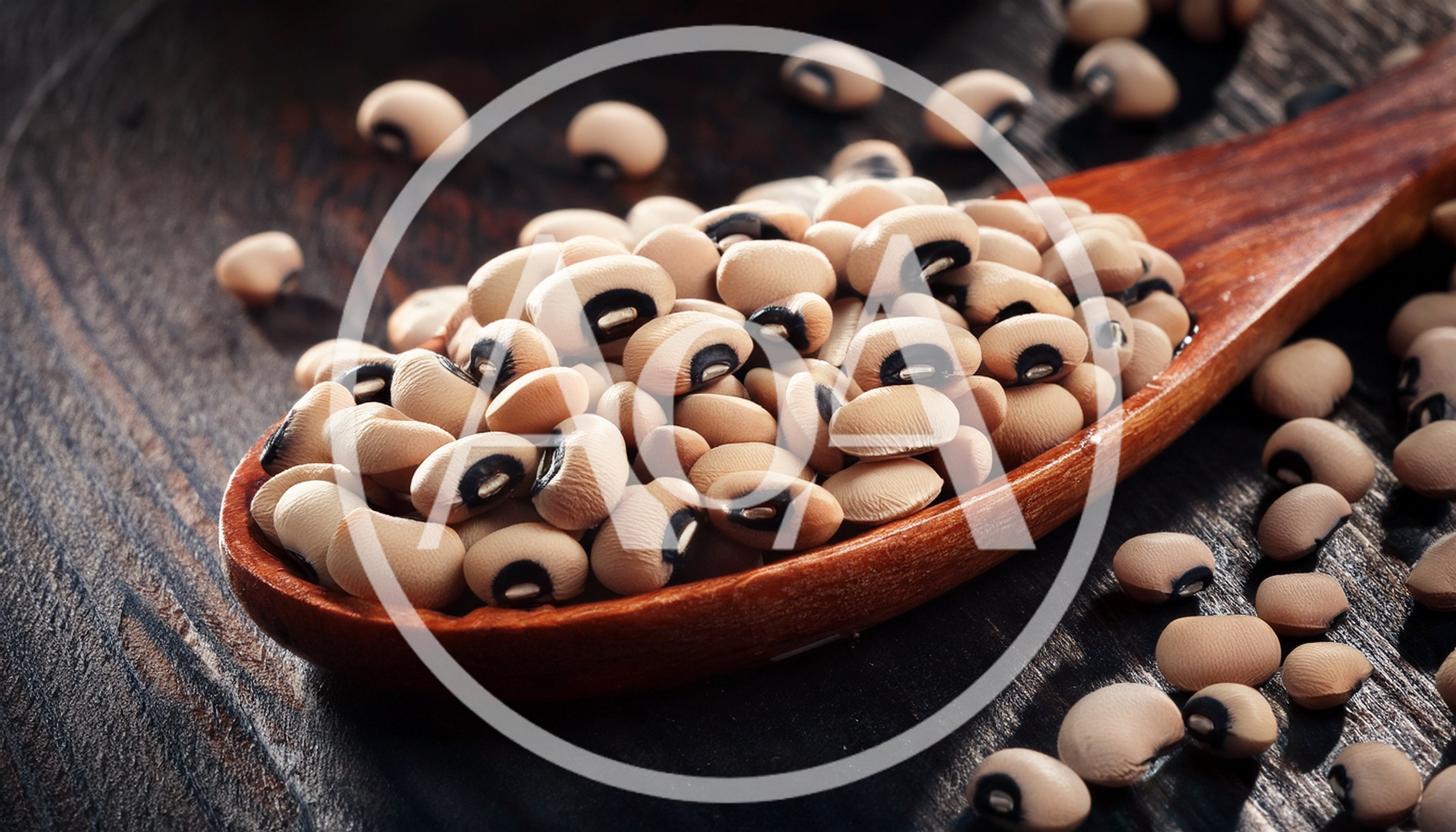 Wooden Spoon Filled With Raw Black Eyed Peas