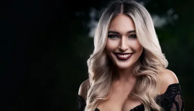 Portrait Of A Smiling Blonde Woman With Dark Lipstick