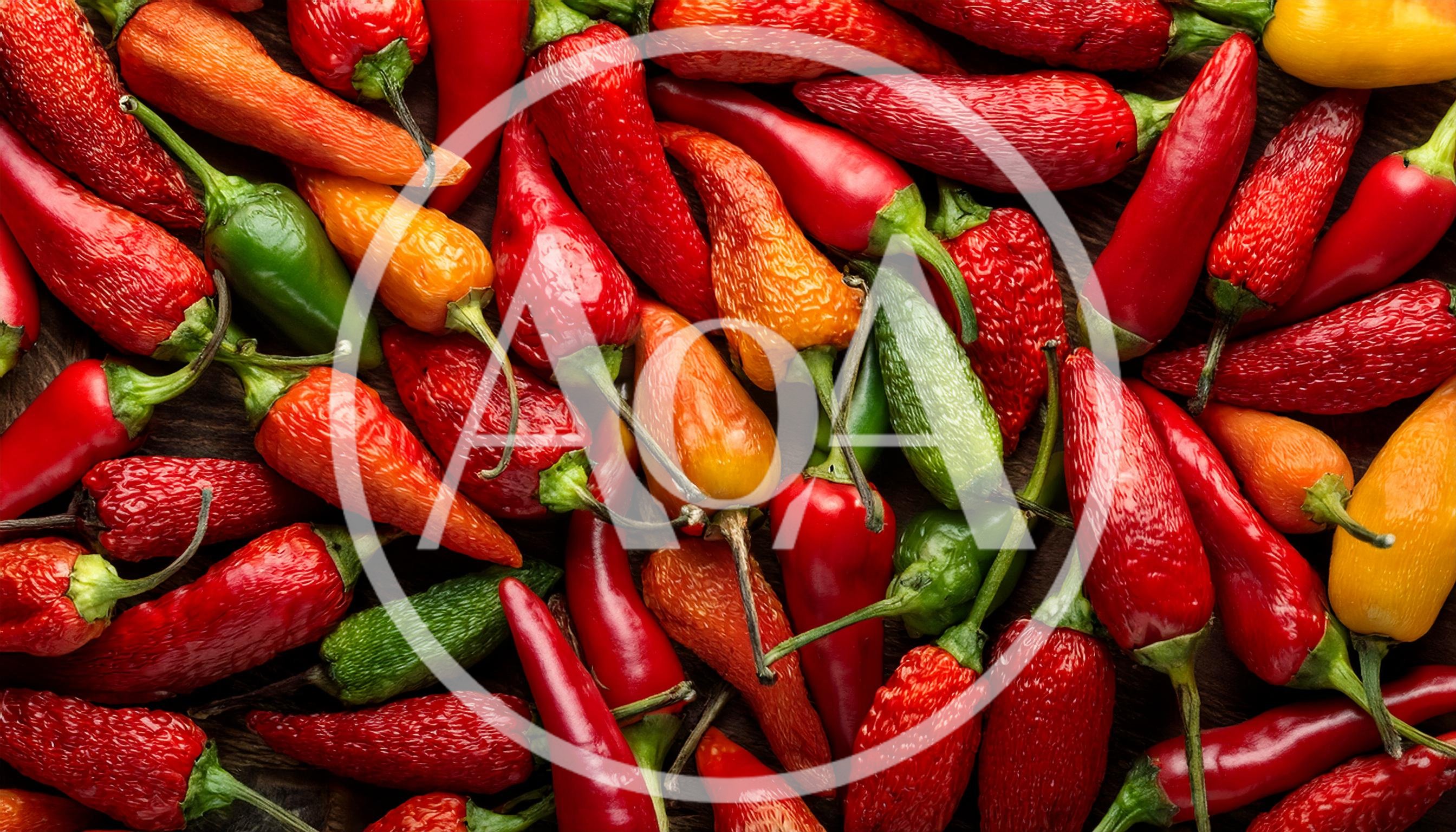 Assorted Fresh Chili Peppers on Wooden Background