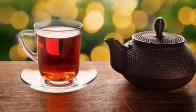 Glass Cup Of Tea And Cast Iron Teapot