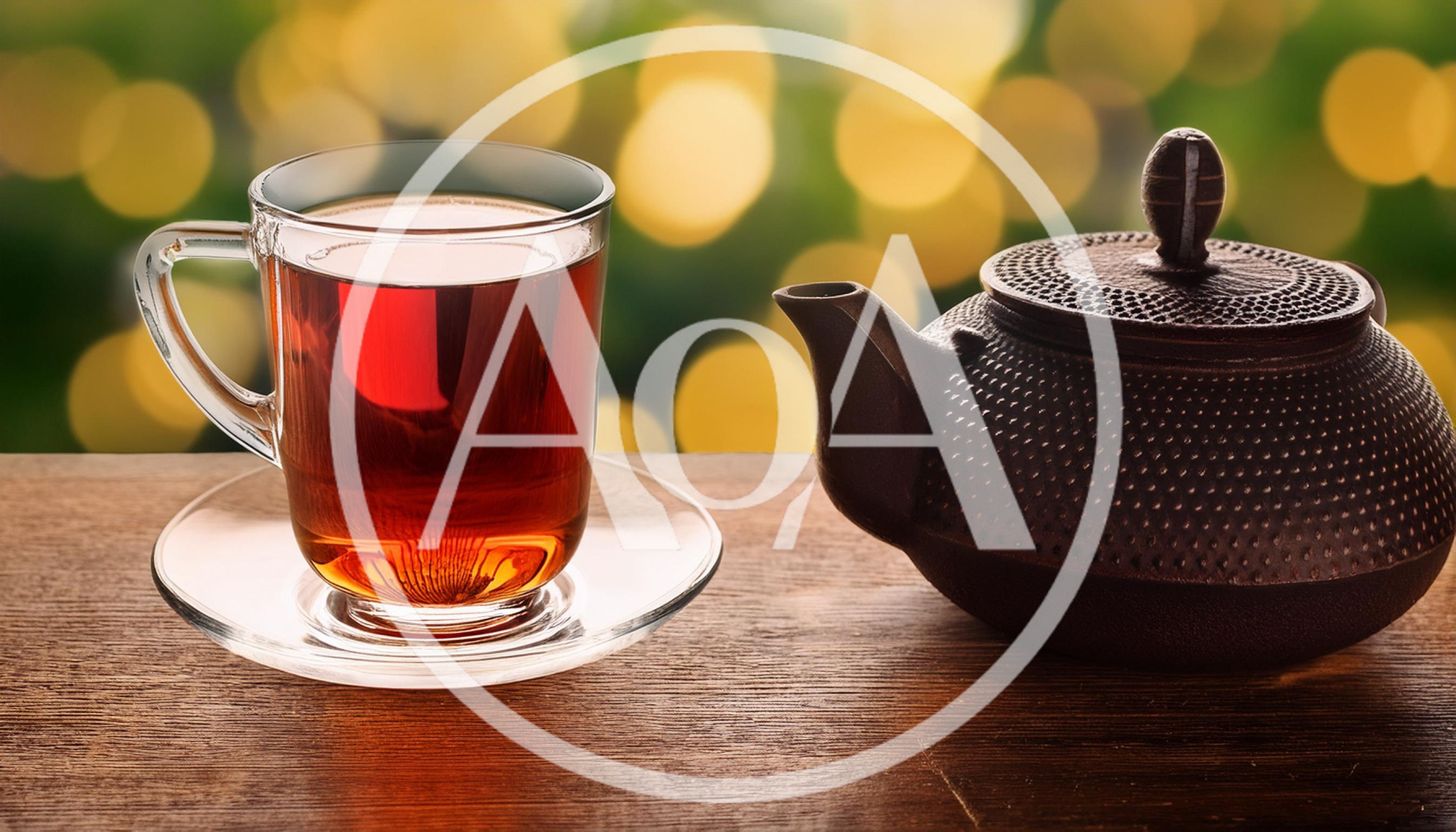 Glass Cup Of Tea And Cast Iron Teapot