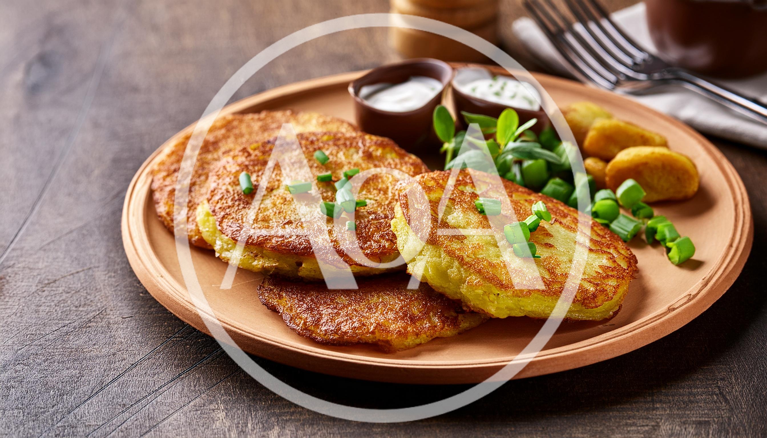 Potato Pancakes Served With Sour Cream And Green Onions