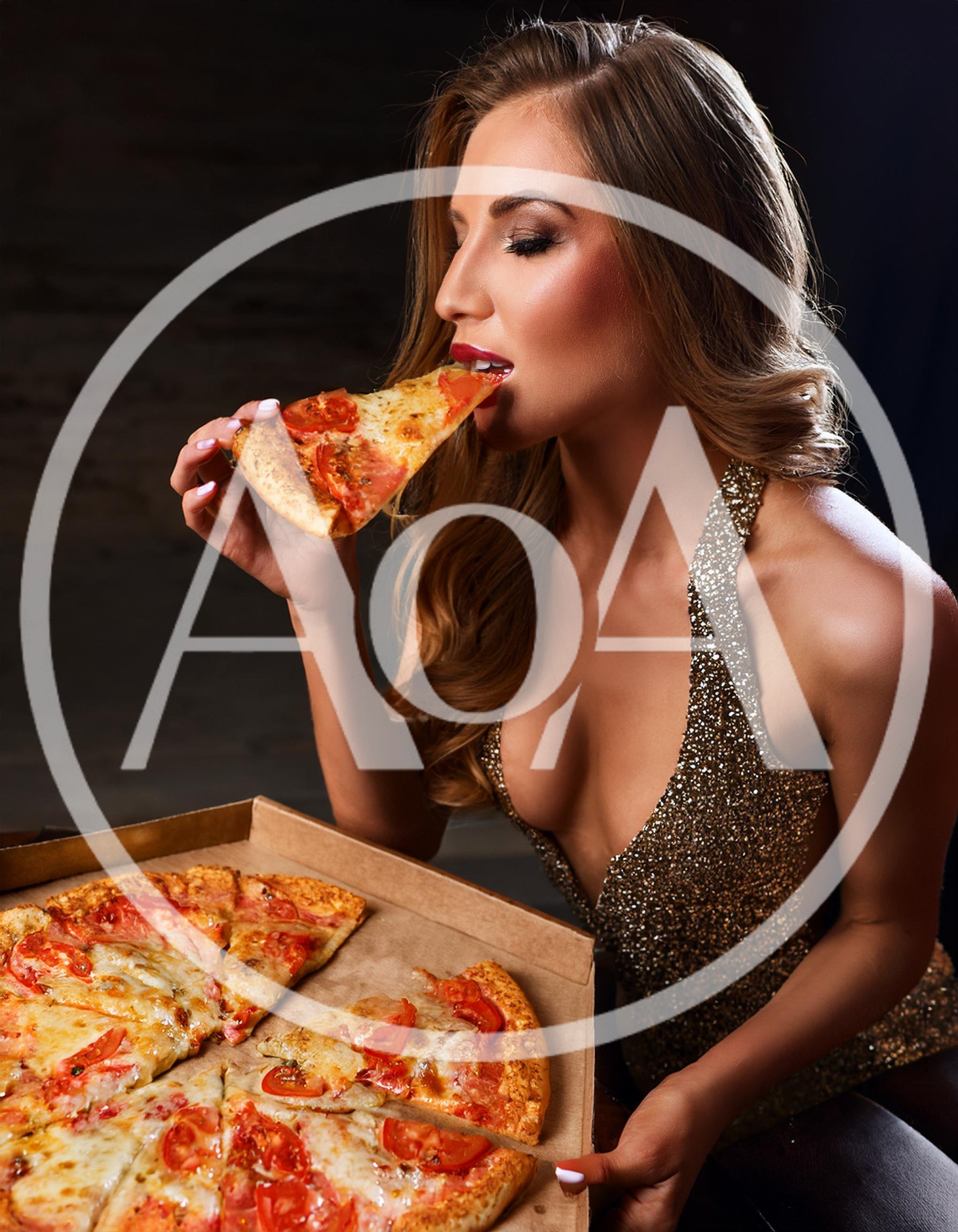 Glamorous Woman Eating Pizza Slice In Evening Wear