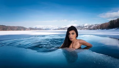 Woman Swimming In A Frozen Lake Hole