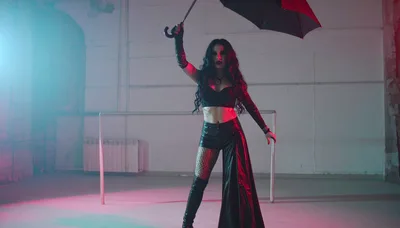 Gothic Woman Posing With Umbrella In Industrial Studio