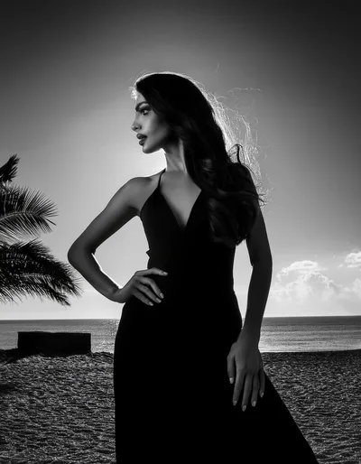 Elegant Woman Posing In Black Dress On Beach