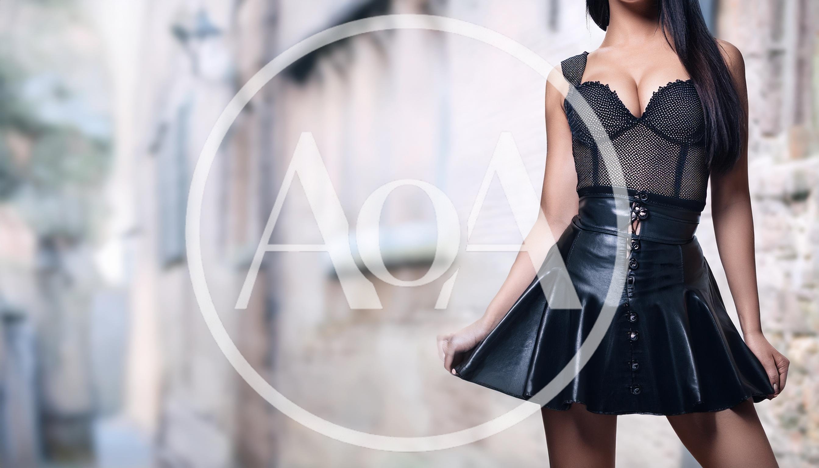 Woman Wearing Black Leather Skirt And Mesh Bodysuit