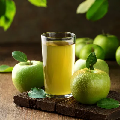 Glass Of Fresh Green Apple Juice On Wooden Board