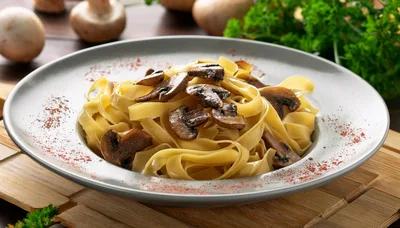 Mushroom Fettuccine Pasta Dish on Wooden Table