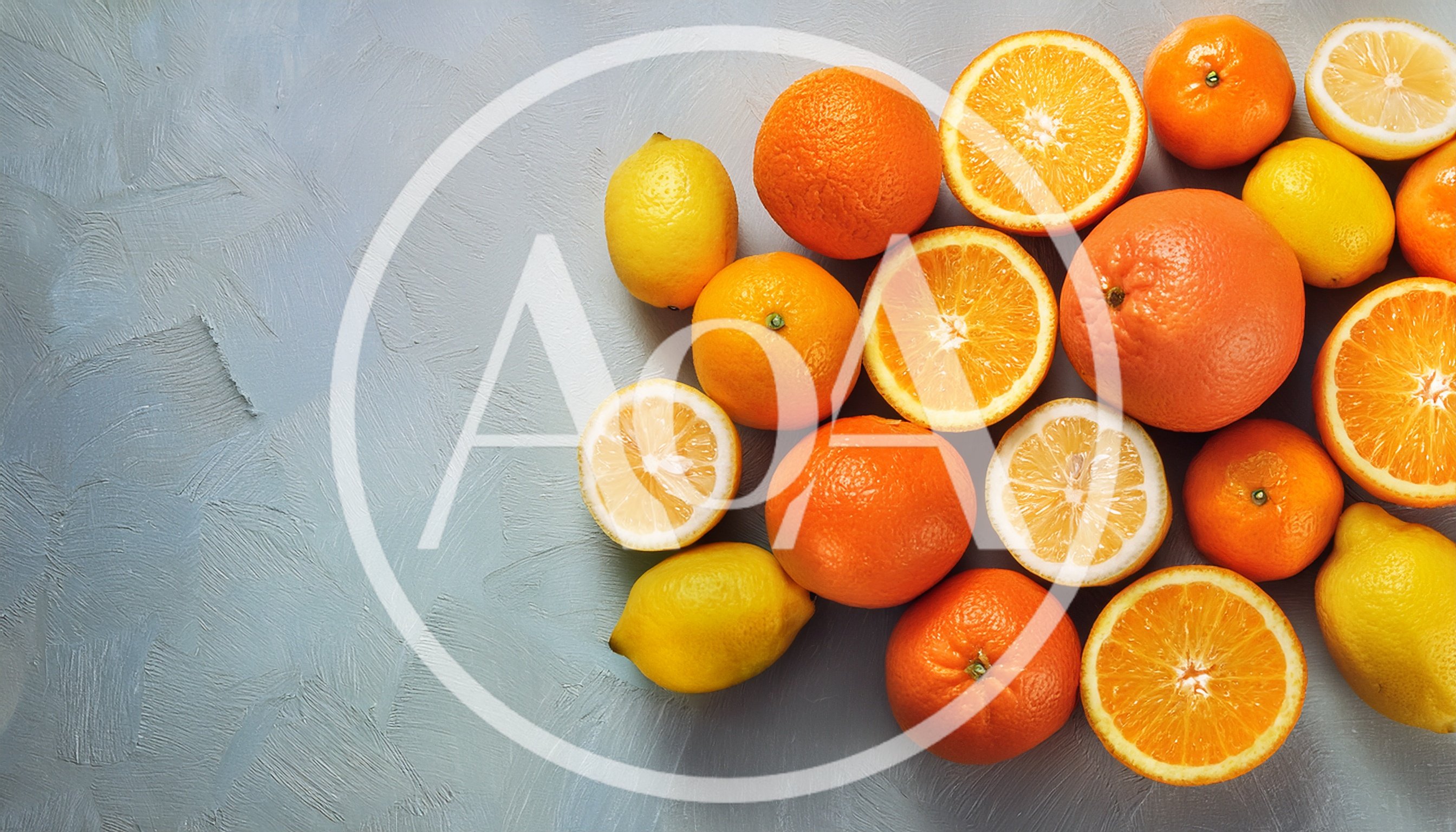 Assorted Citrus Fruits on Textured Gray Background