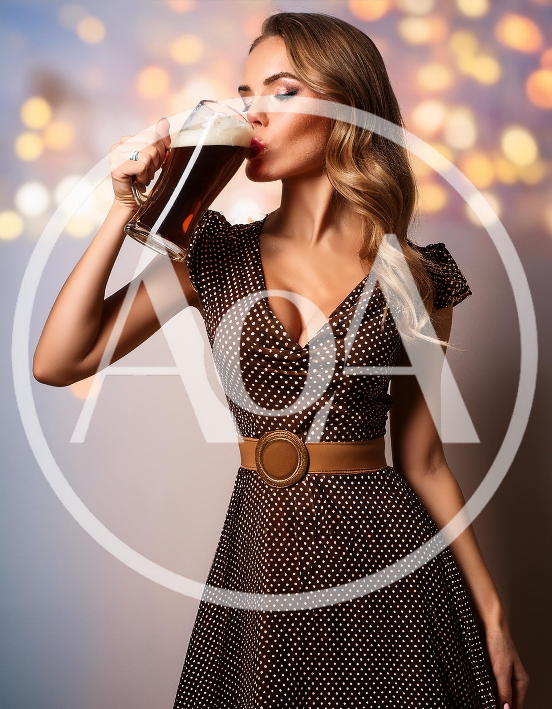 Beautiful Woman Drinking Dark Beer From A Glass Mug