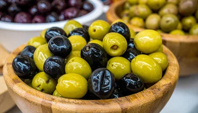 Assorted Green and Black Olives in Wooden Bowls
