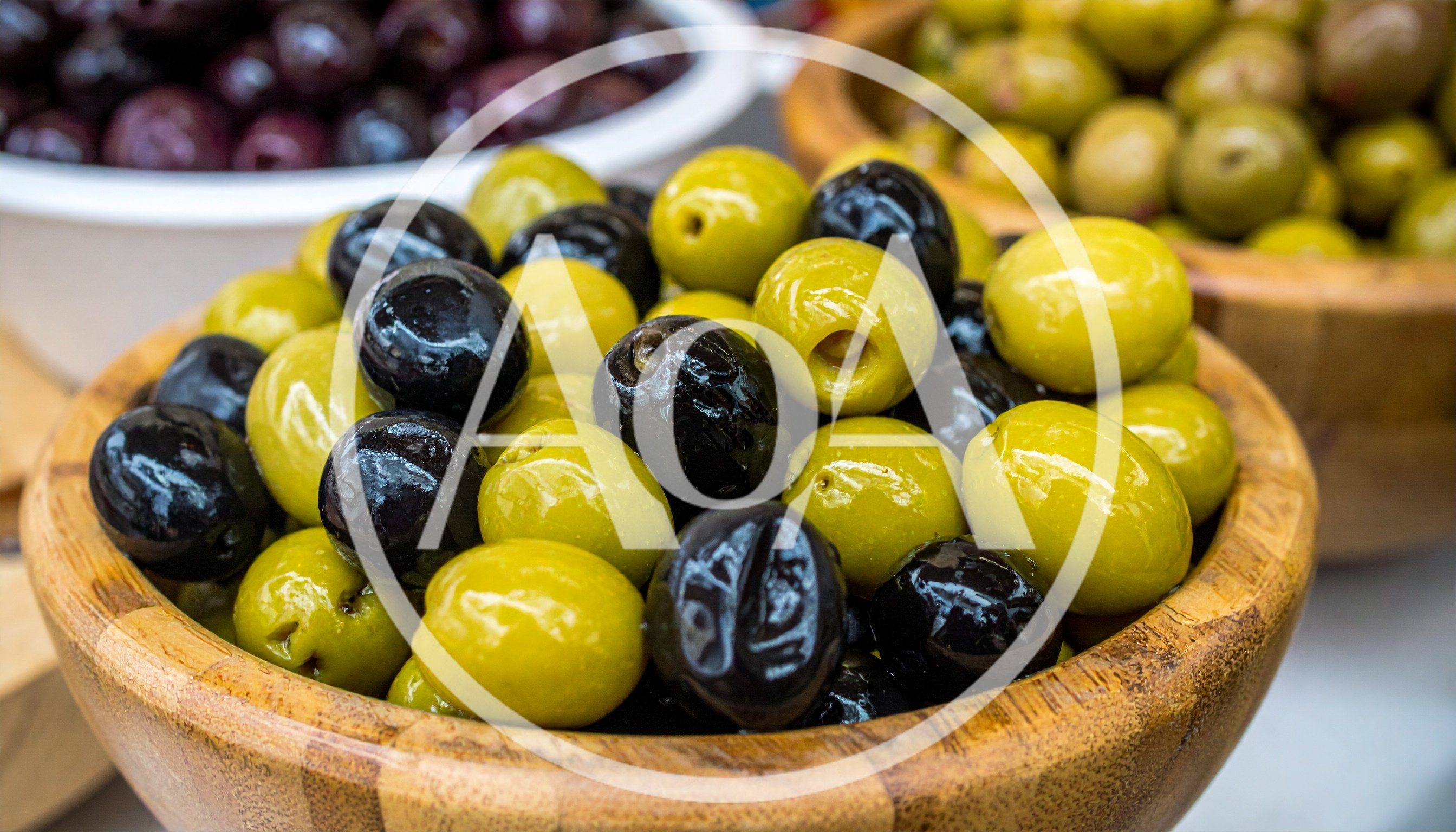Assorted Green and Black Olives in Wooden Bowls