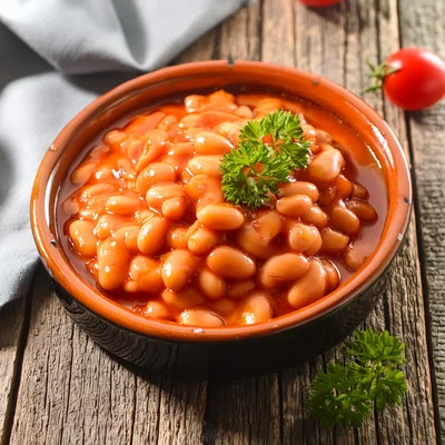 Bowl Of Baked Beans With Parsley Garnish
