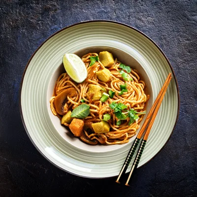 Bowl Of Spicy Vegetable Noodles With Lime