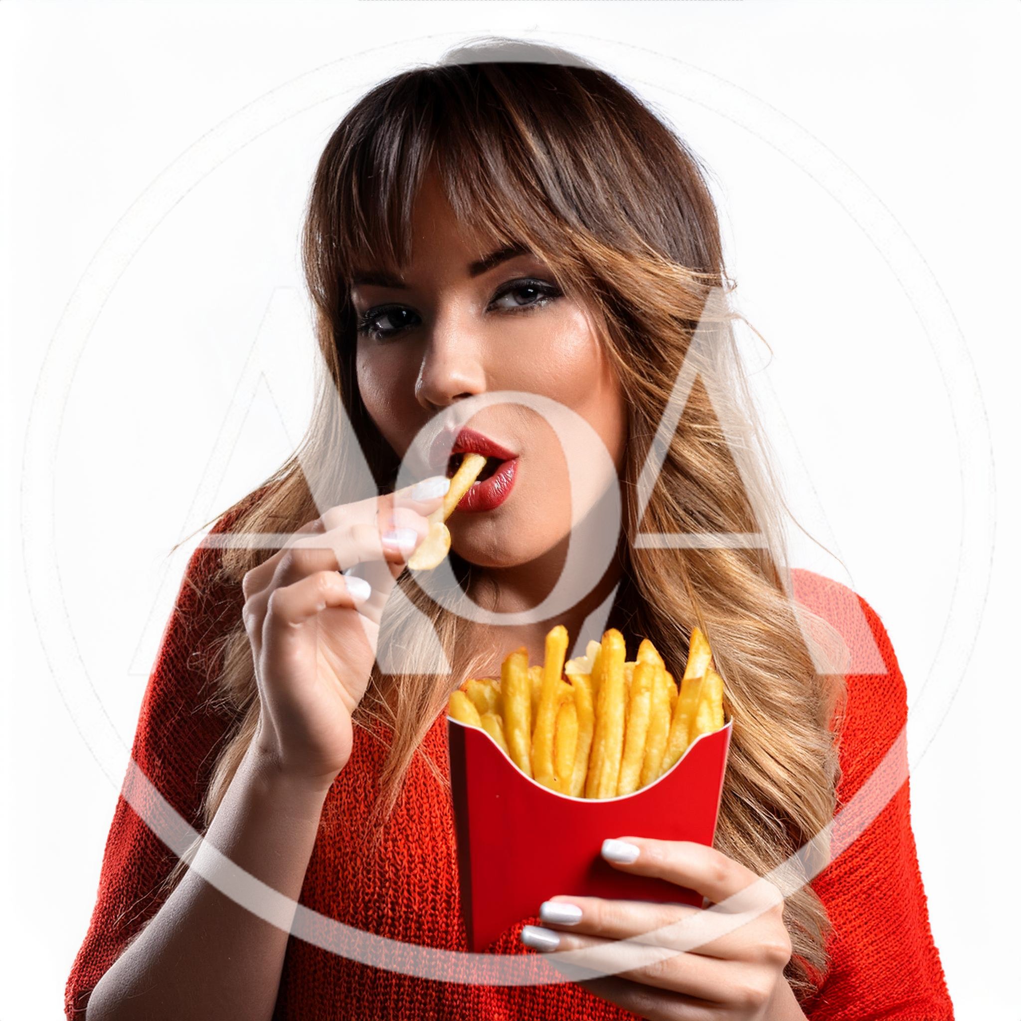 Young Woman Eating French Fries From A Red Carton